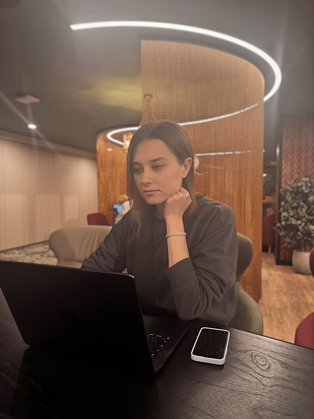 Alona working at her laptop