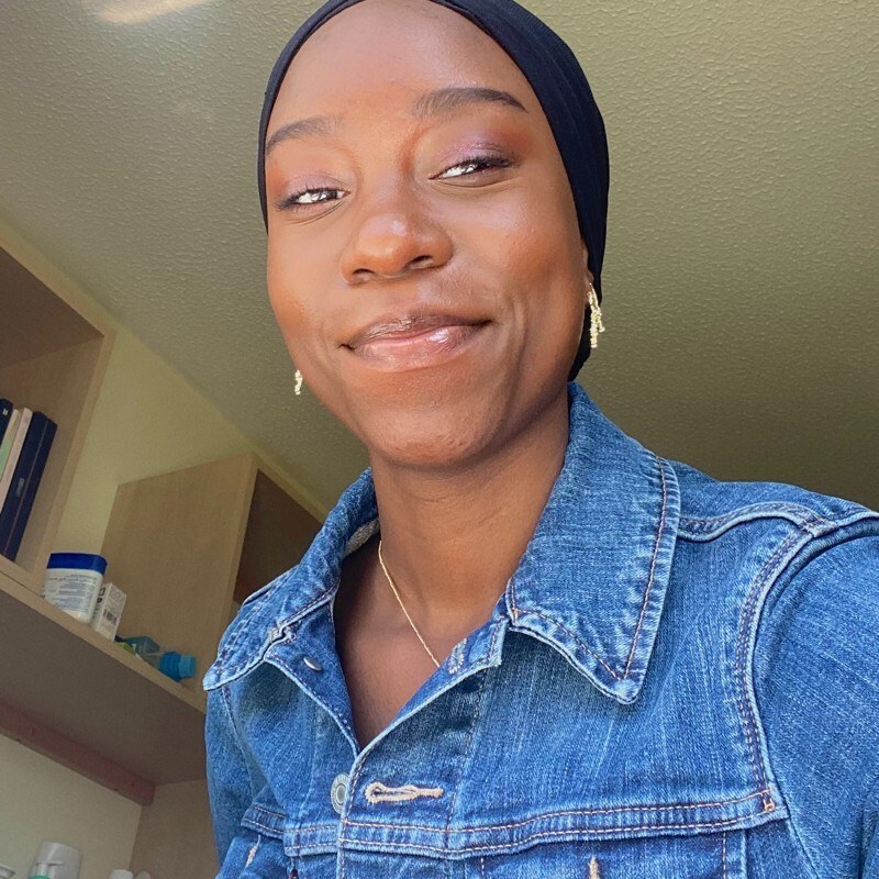 A photo of a young Black woman in a denim jacket.