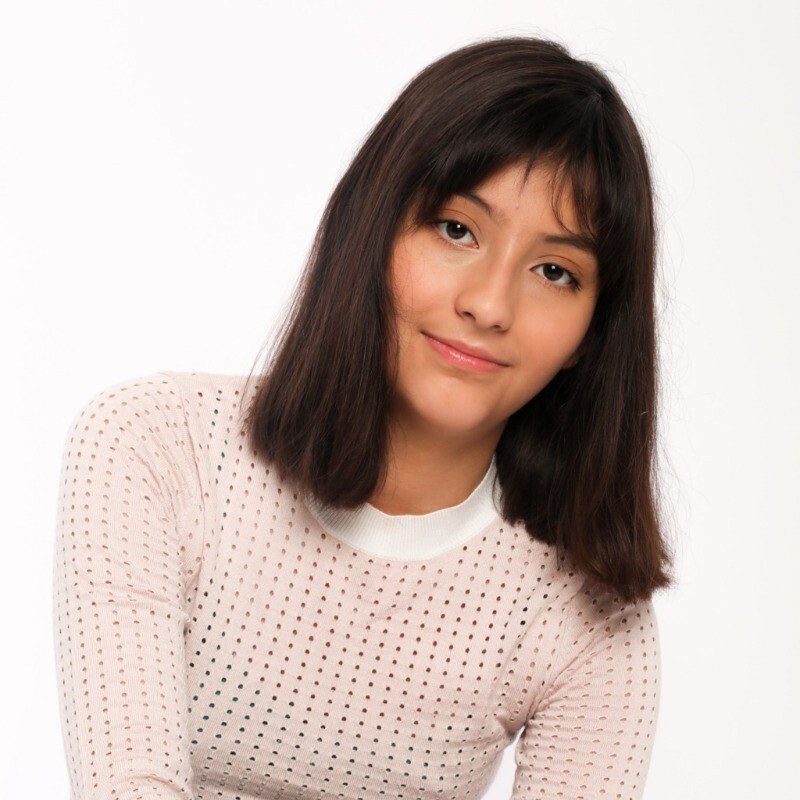 A photo of Britney, a young woman and member of the NTG community, smiling.