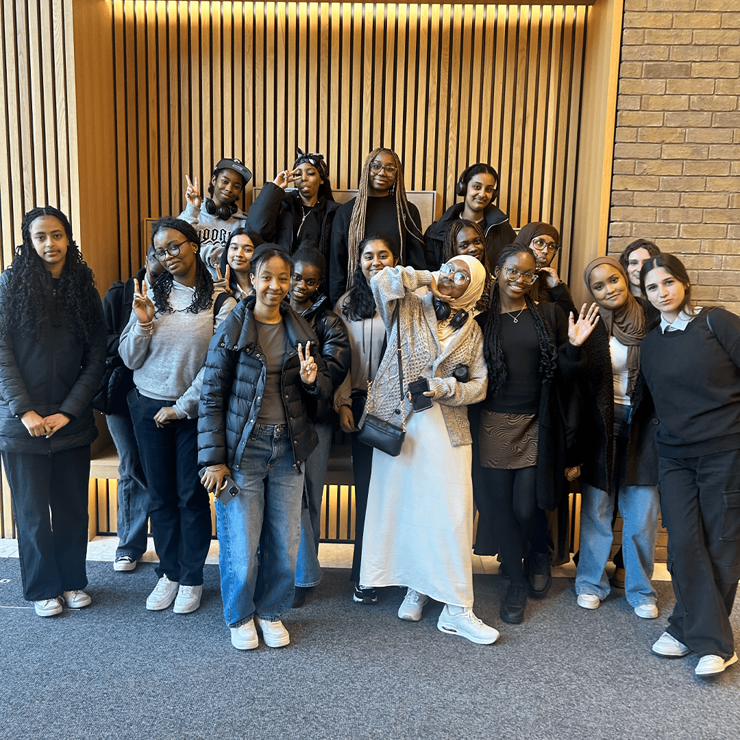 A group of young women smiling and posing at a Publicis Media Insight Day.