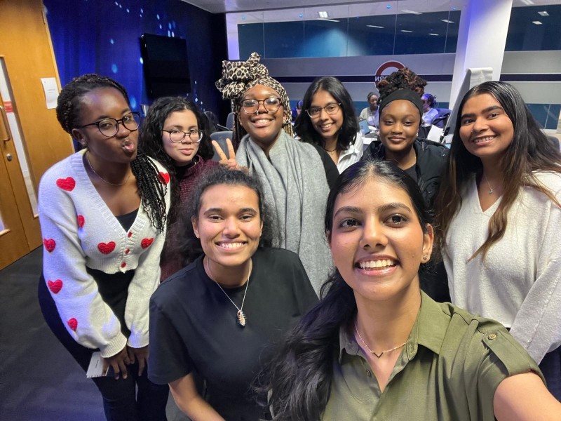 A group of young women pose and smile during their work experience placement with Atos.