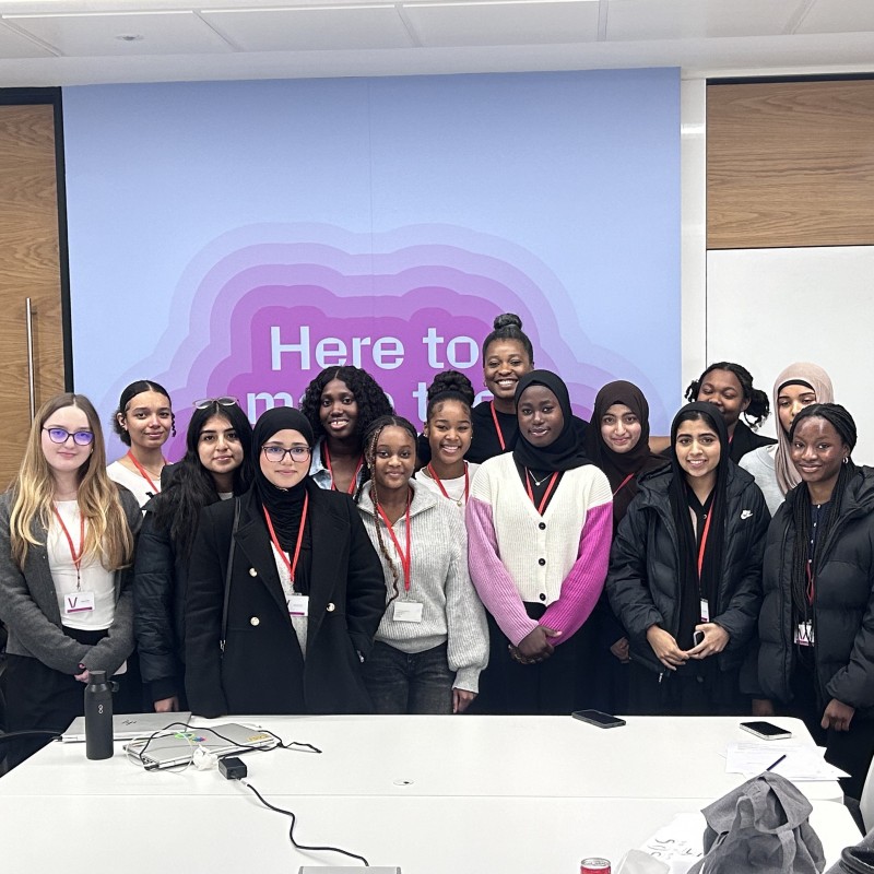A group of young women smile for a photo in the AtkinsRealis offices.